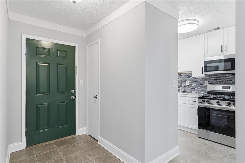 601 Wynnes Ridge Circle Southeast Marietta, GA 30067 - Photo 4 of 28 a kitchen with granite countertop a stove and a refrigerator