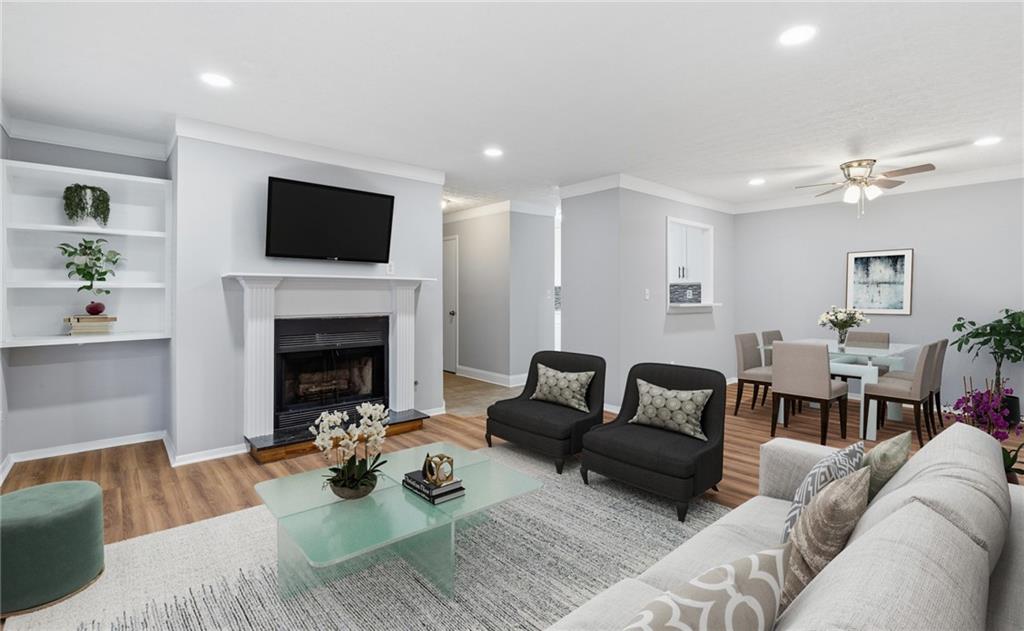 601 Wynnes Ridge Circle Southeast Marietta, GA 30067 - Photo 6 of 28 a living room with furniture a flat screen tv and a fireplace