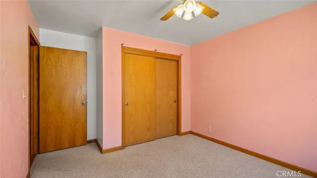 a view of an empty room with a closet