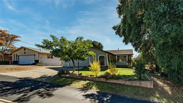 a front view of a house with a yard garage and outdoor seating