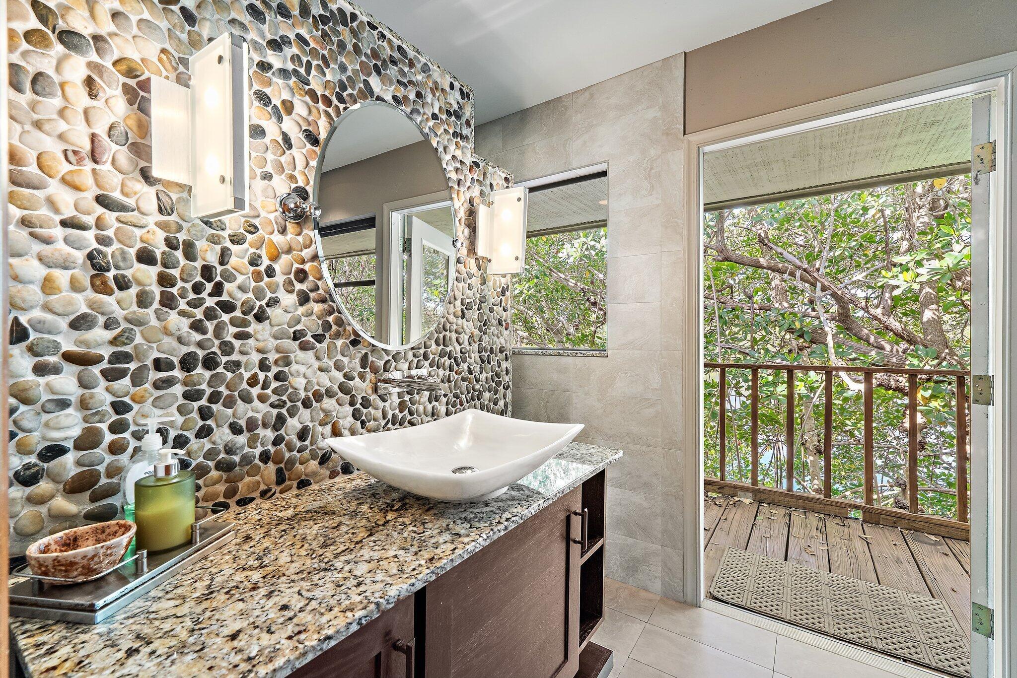 702 Warren Drive Jupiter, FL 33458 - Photo 47 of 76 a bathroom with a granite countertop sink a toilet and shower curtain