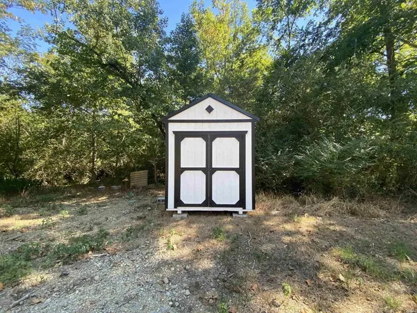 a white house with a trees in the background