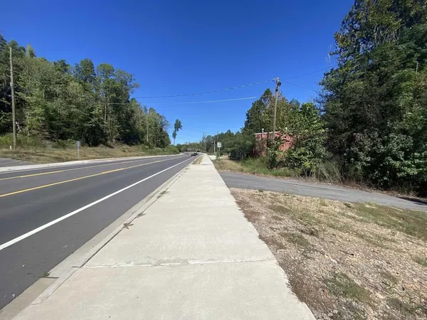 a view of a road with a building in the background