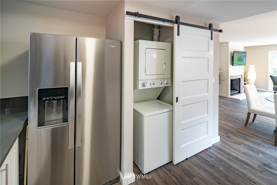 13839-13841 Southeast Allen Rd. Bellevue, WA 98006 - Photo 12 of 25 a kitchen with refrigerator and wooden floor
