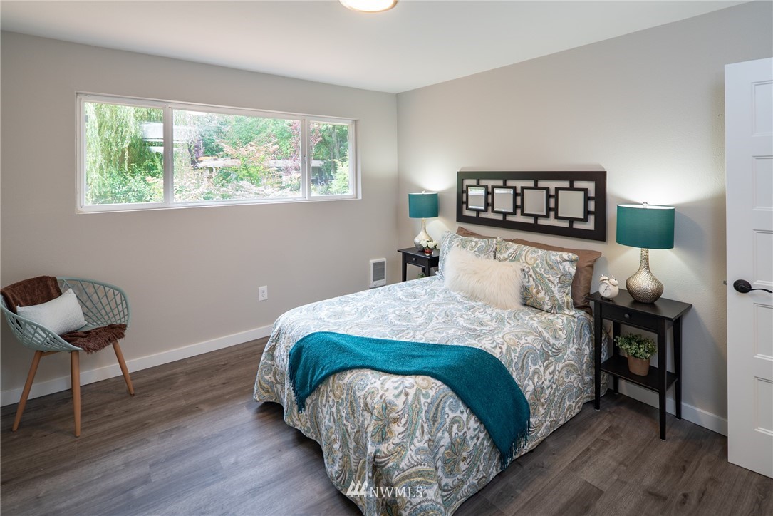 13839-13841 Southeast Allen Rd. Bellevue, WA 98006 - Photo 14 of 25 a bedroom with a bed and a chair