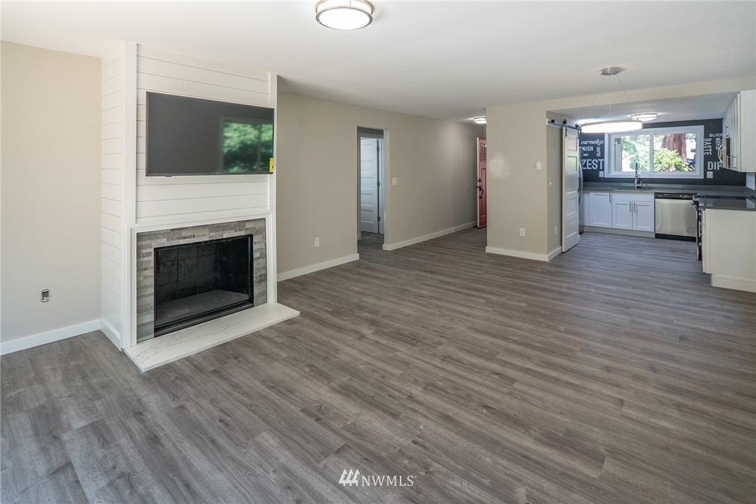 13839-13841 Southeast Allen Rd. Bellevue, WA 98006 - Photo 21 of 25 a view of a livingroom with wooden floor and a fireplace