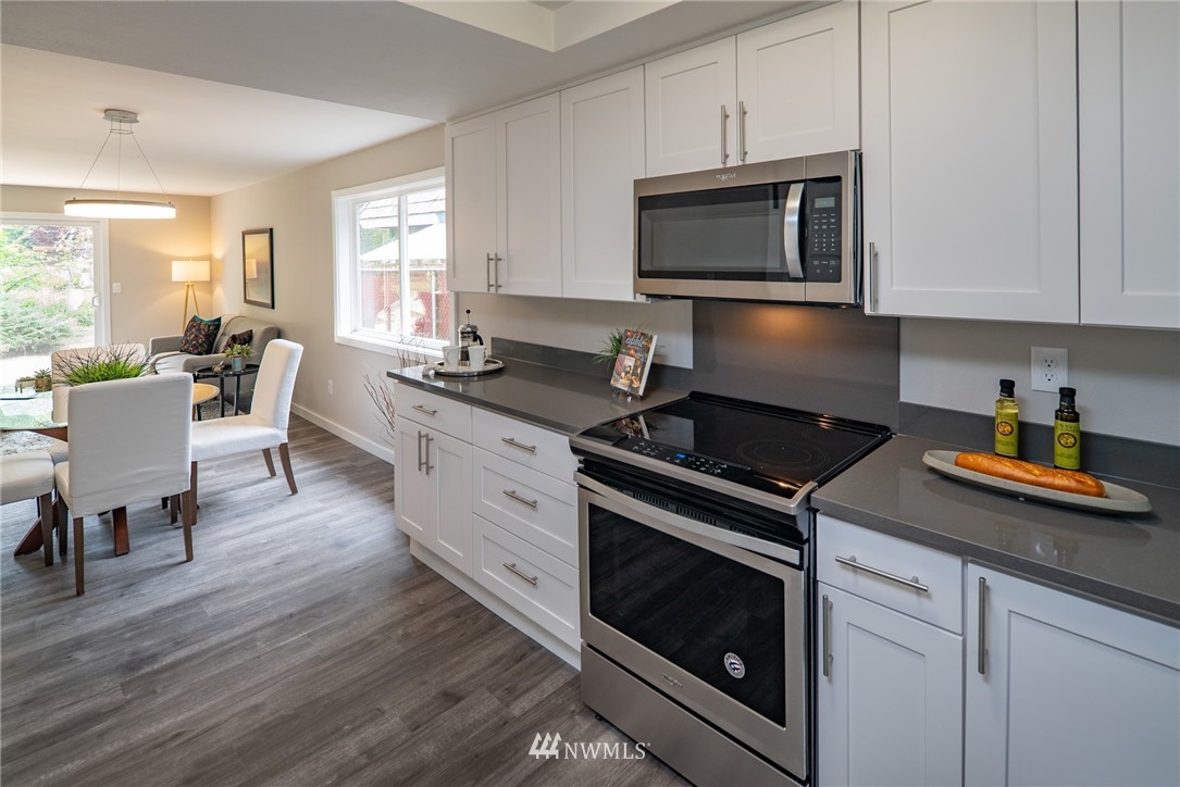 13839-13841 Southeast Allen Rd. Bellevue, WA 98006 - Photo 10 of 25 a kitchen with stainless steel appliances a stove a microwave and cabinets