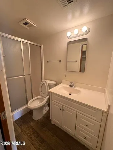 a bathroom with a toilet a sink a mirror and vanity