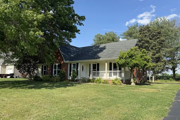 a front view of house with yard and green space