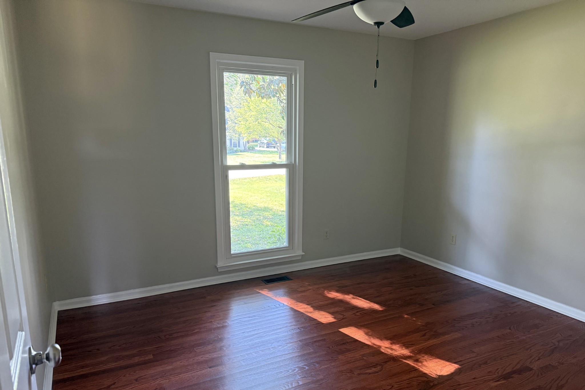 206 Stephens Hill Road Franklin, KY 42134 - Photo 11 of 21 an empty room with wooden floor and windows