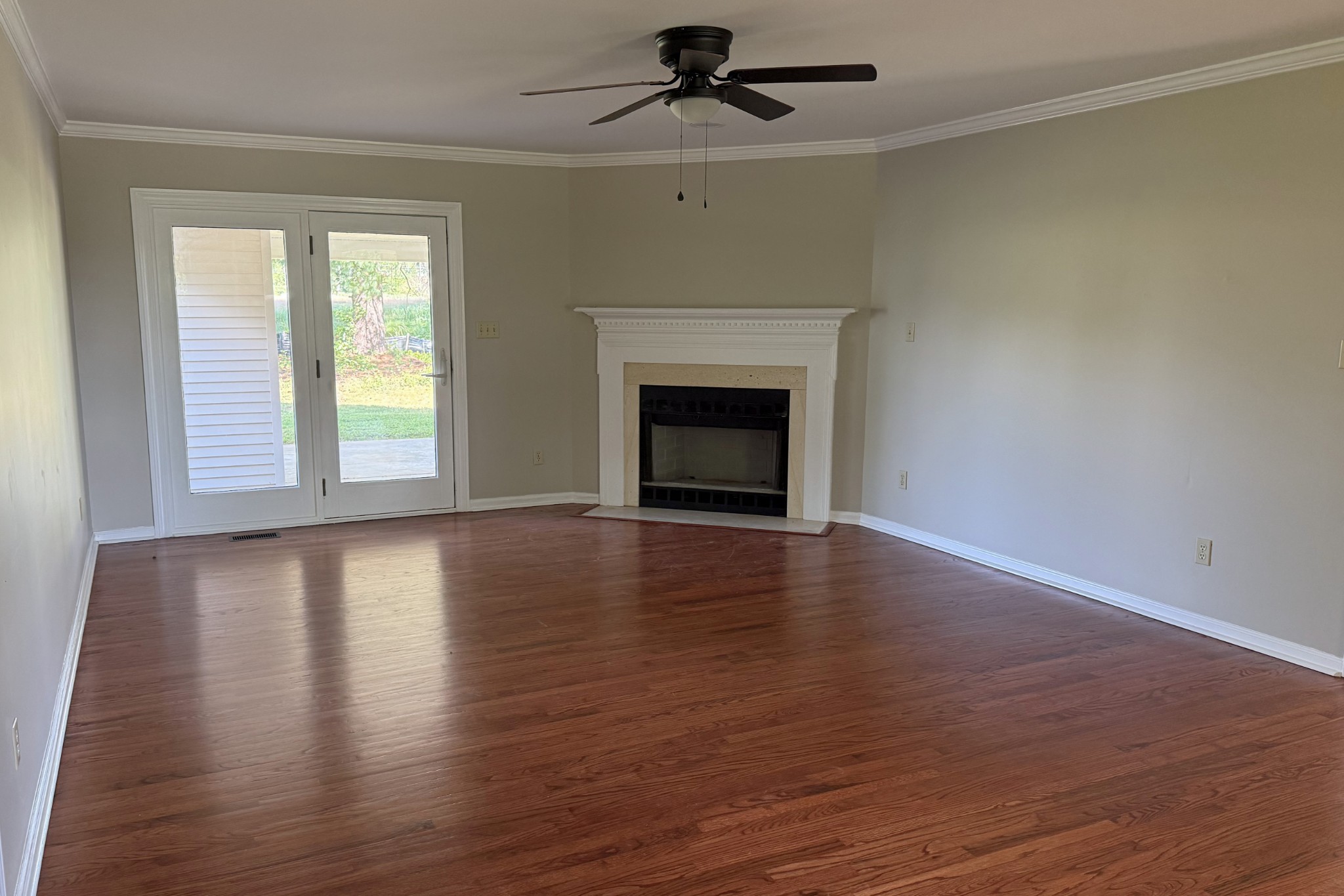 206 Stephens Hill Road Franklin, KY 42134 - Photo 4 of 21 an empty room with wooden floor fireplace and windows