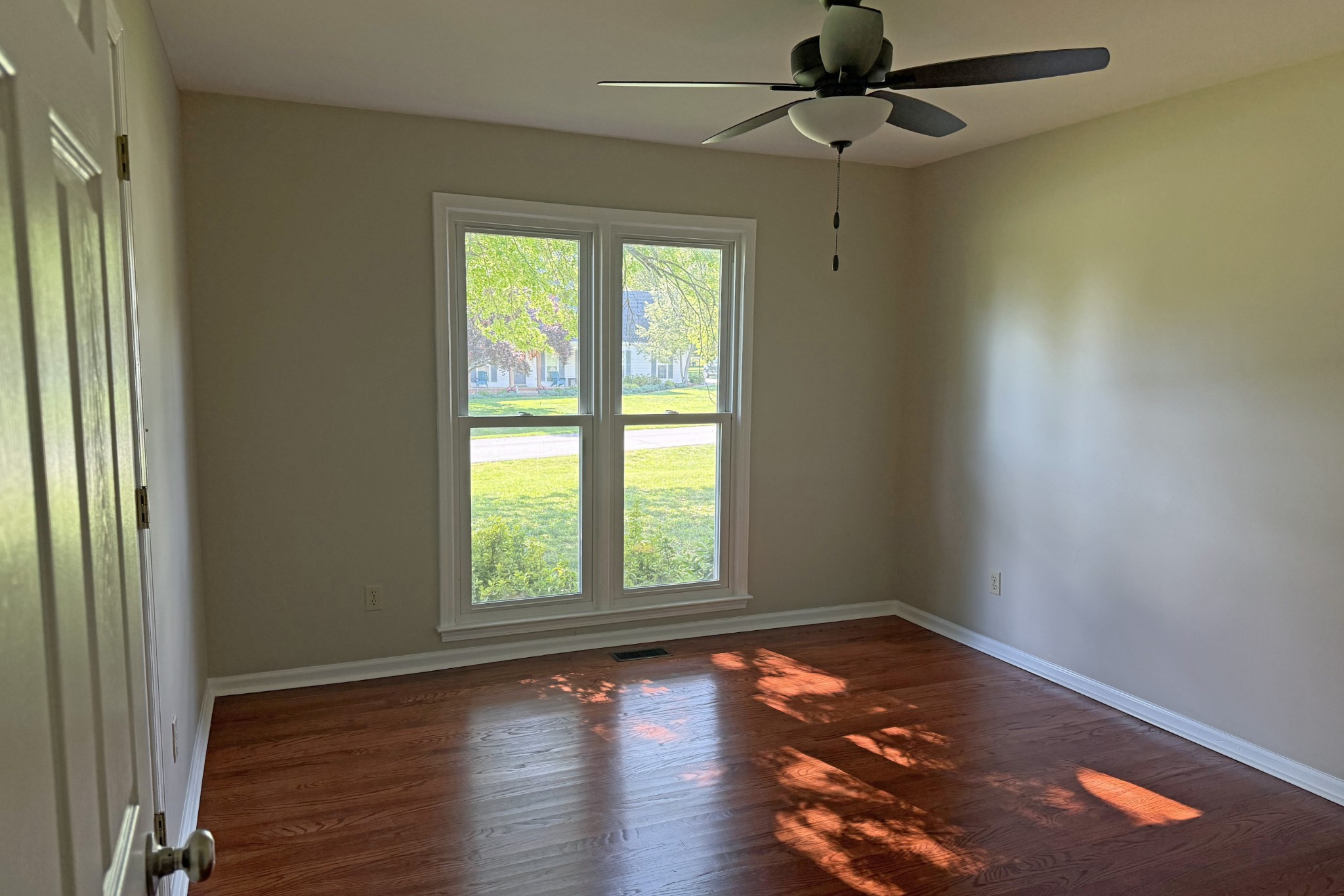 206 Stephens Hill Road Franklin, KY 42134 - Photo 10 of 21 an empty room with wooden floor chandelier fan and windows