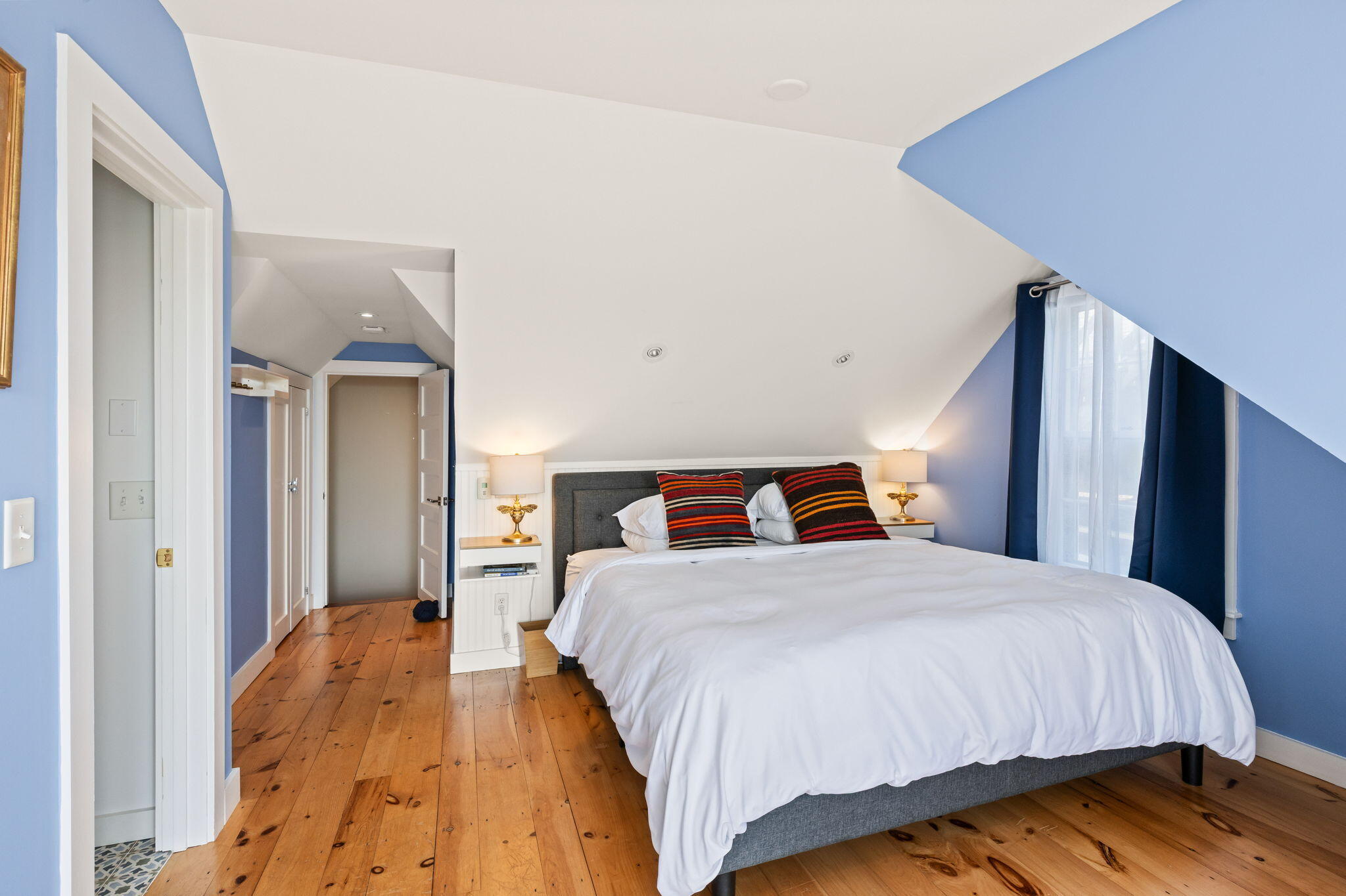 342 B Commercial Street Provincetown, MA 02657 - Photo 28 of 42 a bedroom with a bed and a mirror