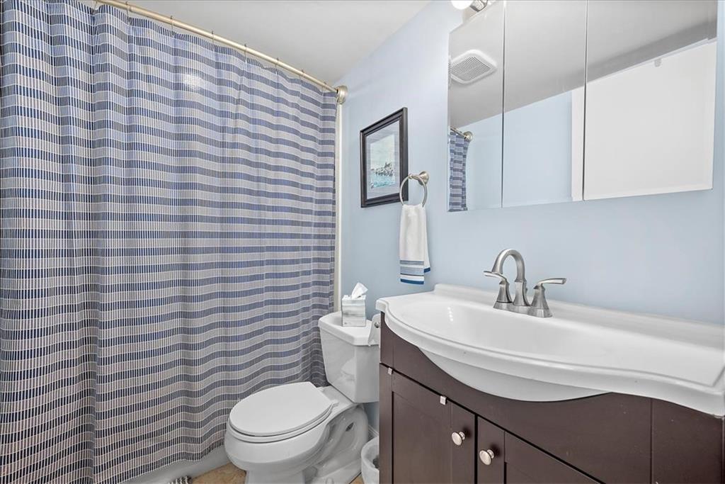 5 Bayard Road, Unit 617 Pittsburgh, PA 15213 - Photo 12 of 15 a bathroom with a sink a toilet and mirror