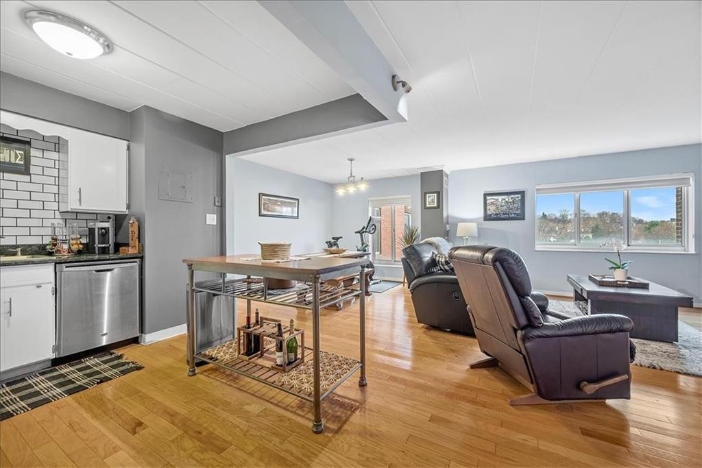 5 Bayard Road, Unit 617 Pittsburgh, PA 15213 - Photo 3 of 15 a living room with furniture a dining table and kitchen view