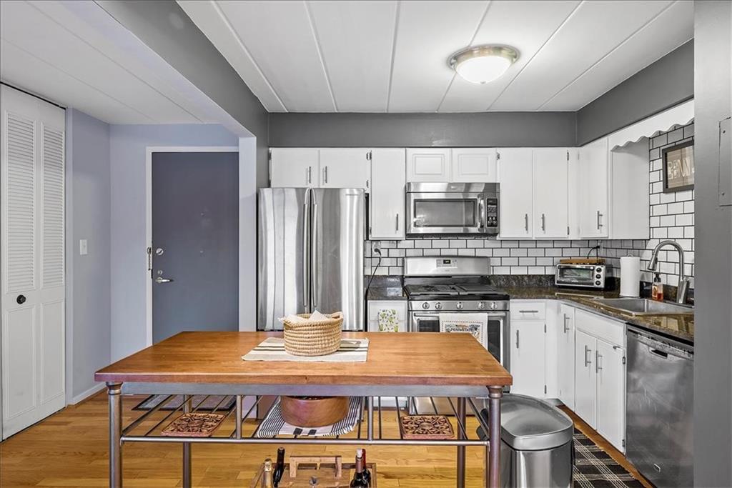 5 Bayard Road, Unit 617 Pittsburgh, PA 15213 - Photo 4 of 15 a kitchen with stainless steel appliances granite countertop a stove refrigerator and a sink