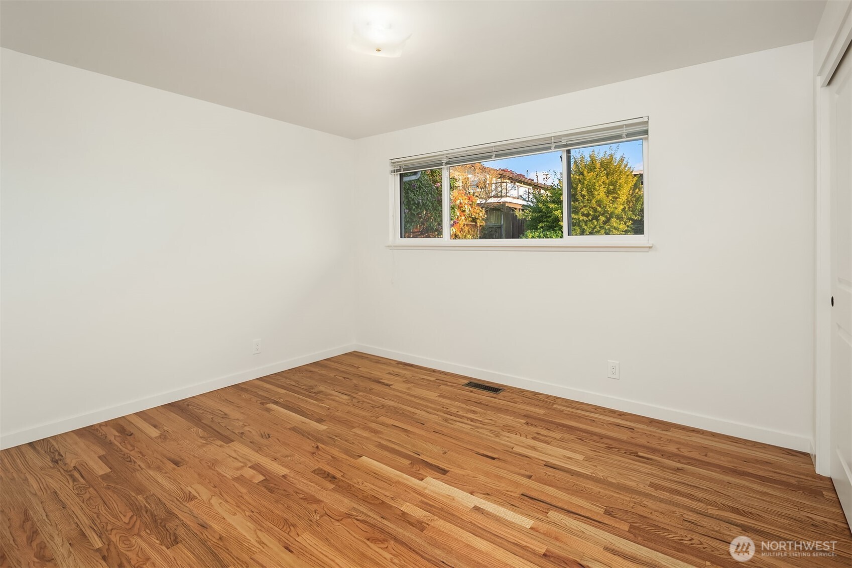 814 Dayton Street Edmonds, WA 98020 - Photo 24 of 36 an empty room with wooden floor and windows