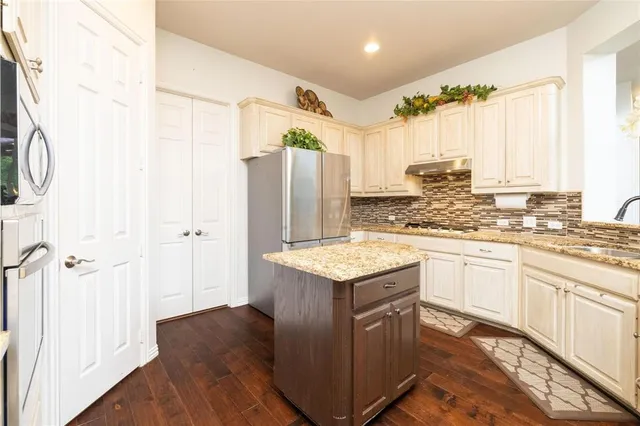 a kitchen with a sink stove and refrigerator