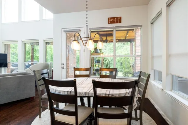 a dining room with furniture a chandelier and wooden floor