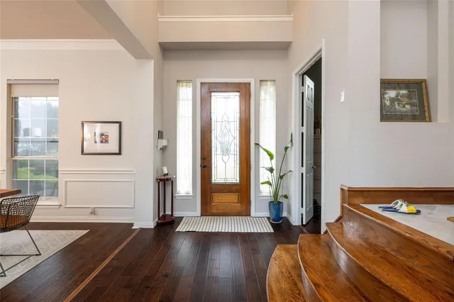 a view of a bedroom with wooden floor and windows