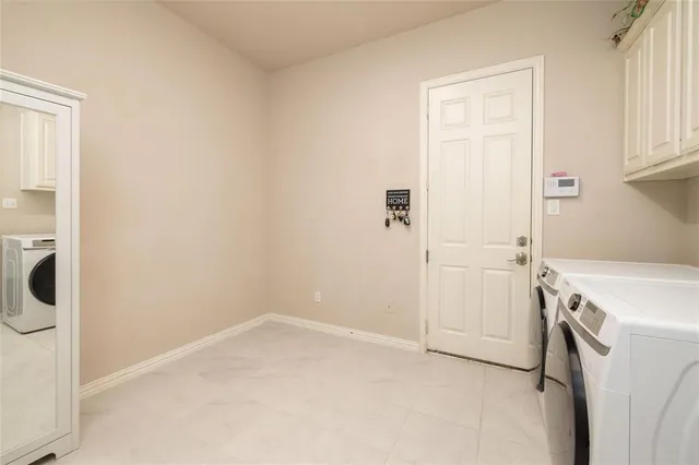 a view of a patio with table and chairs potted plants and floor to ceiling window