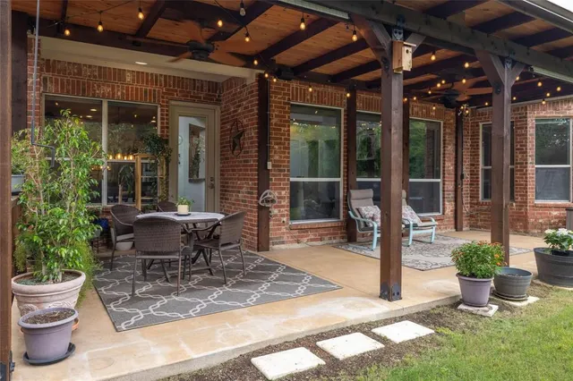 a view of a house with a backyard porch and sitting area
