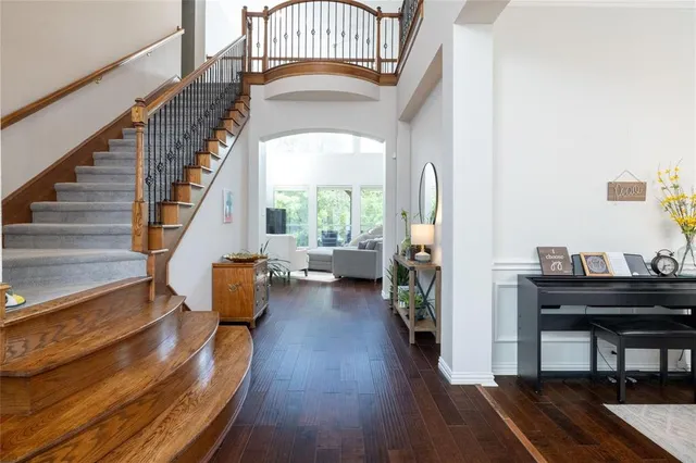 a view of entryway and hall with wooden floor