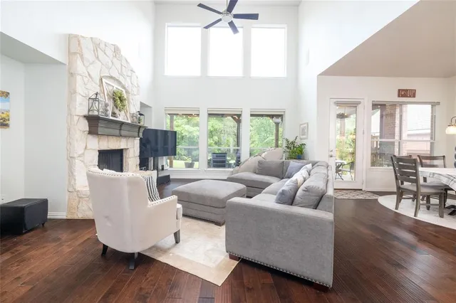 a living room with furniture a fireplace and a large window