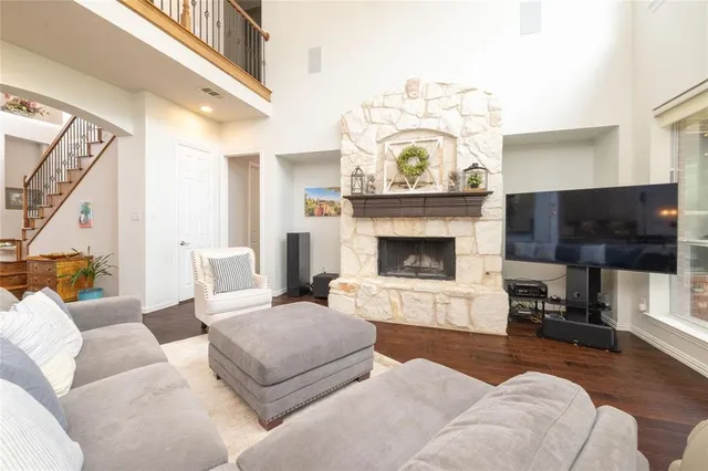 a living room with furniture a flat screen tv and a fireplace