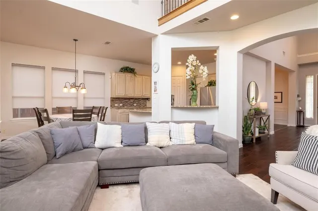 a living room with furniture and kitchen view
