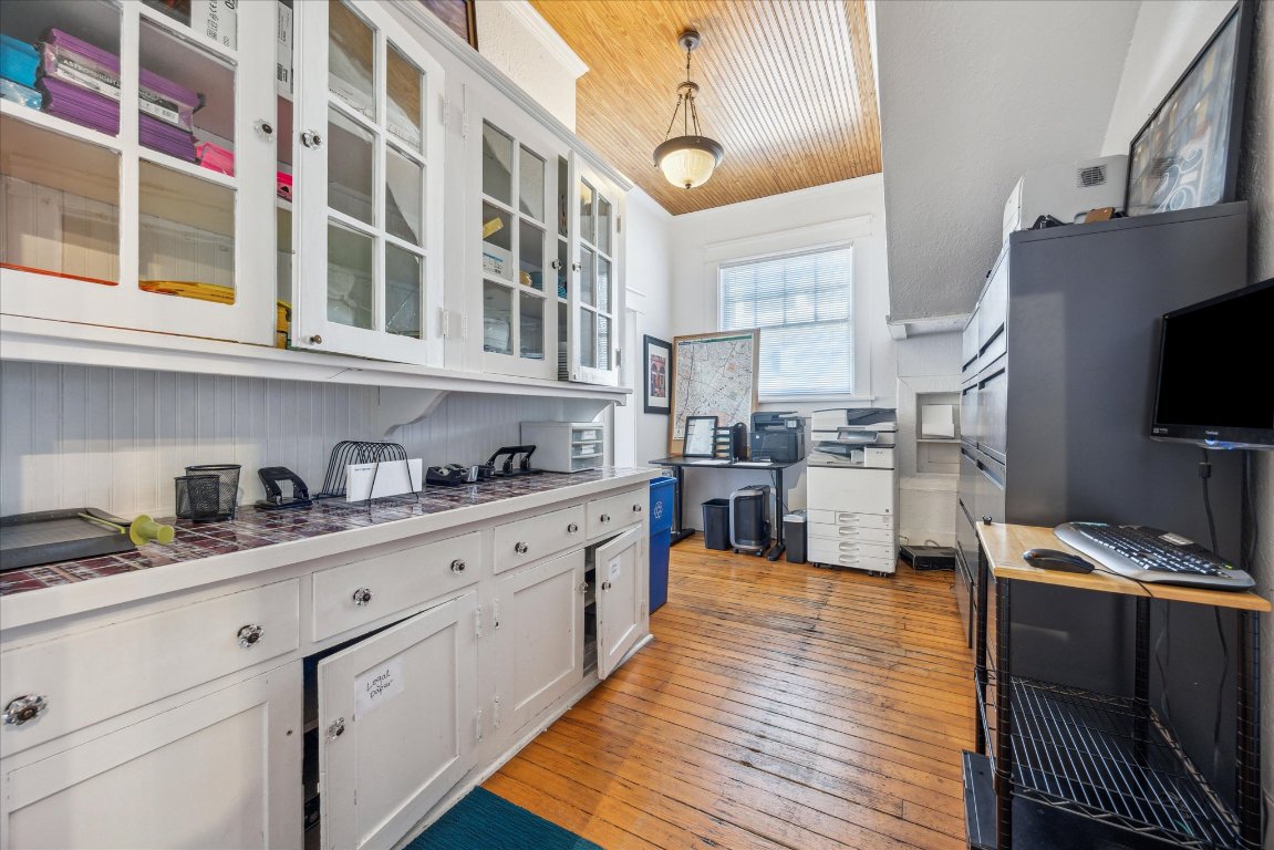 2404 Rio Grande Street Austin, TX 78705 - Photo 14 of 28 a kitchen with cabinets and wooden floor