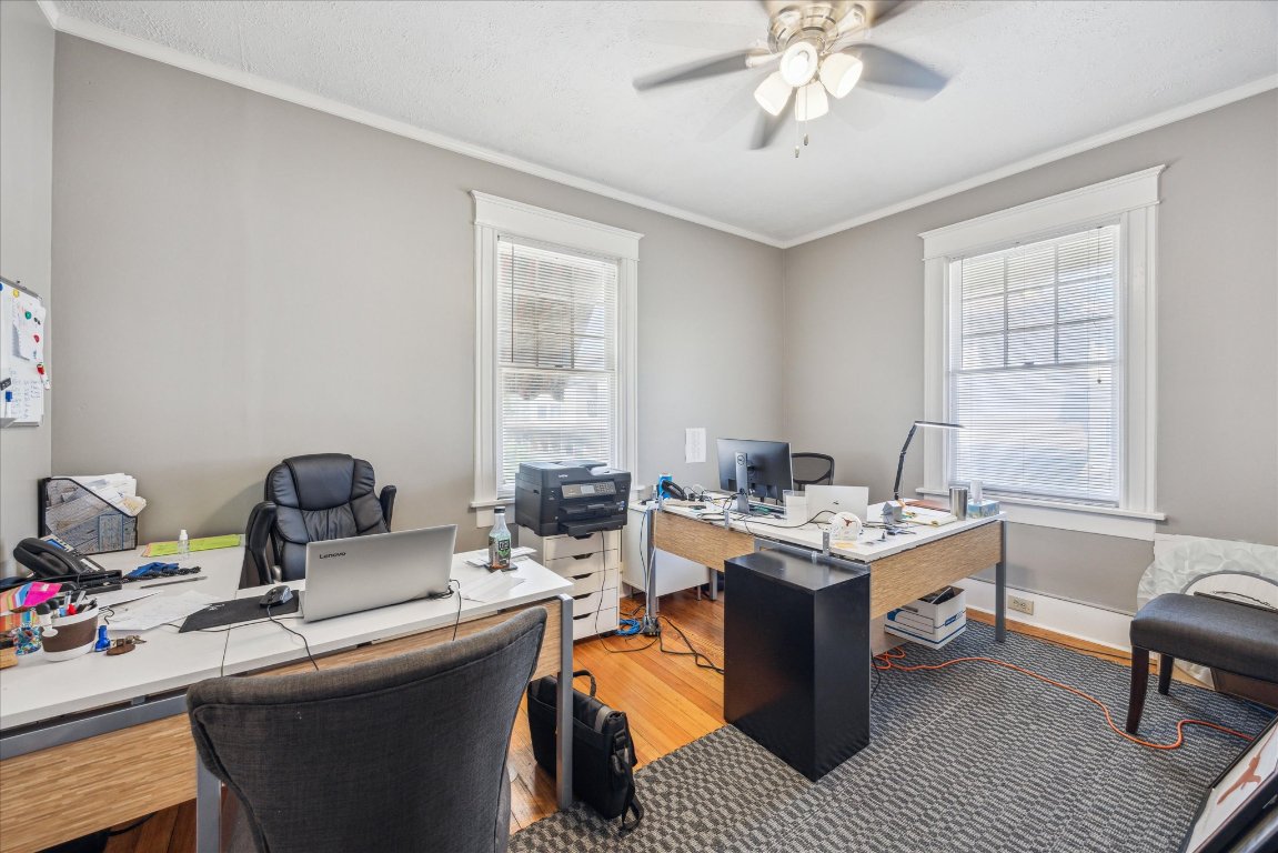 2404 Rio Grande Street Austin, TX 78705 - Photo 18 of 28 a work room with furniture a chandelier and a window