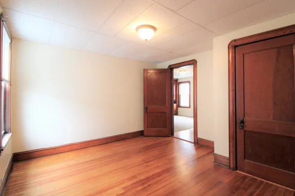 a view of a livingroom with an empty space and a window