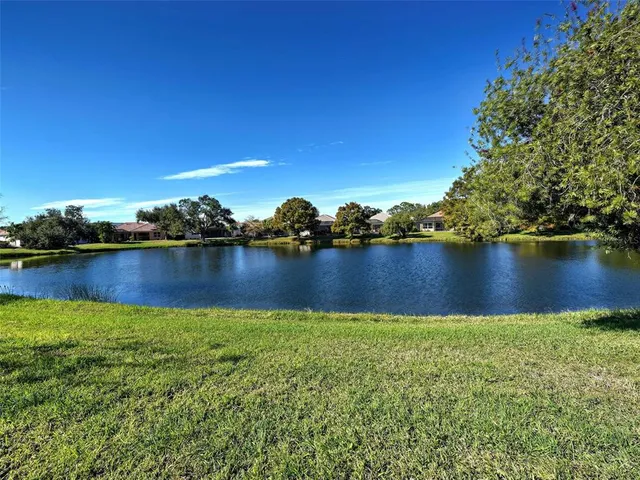 a view of a lake with a house in the background