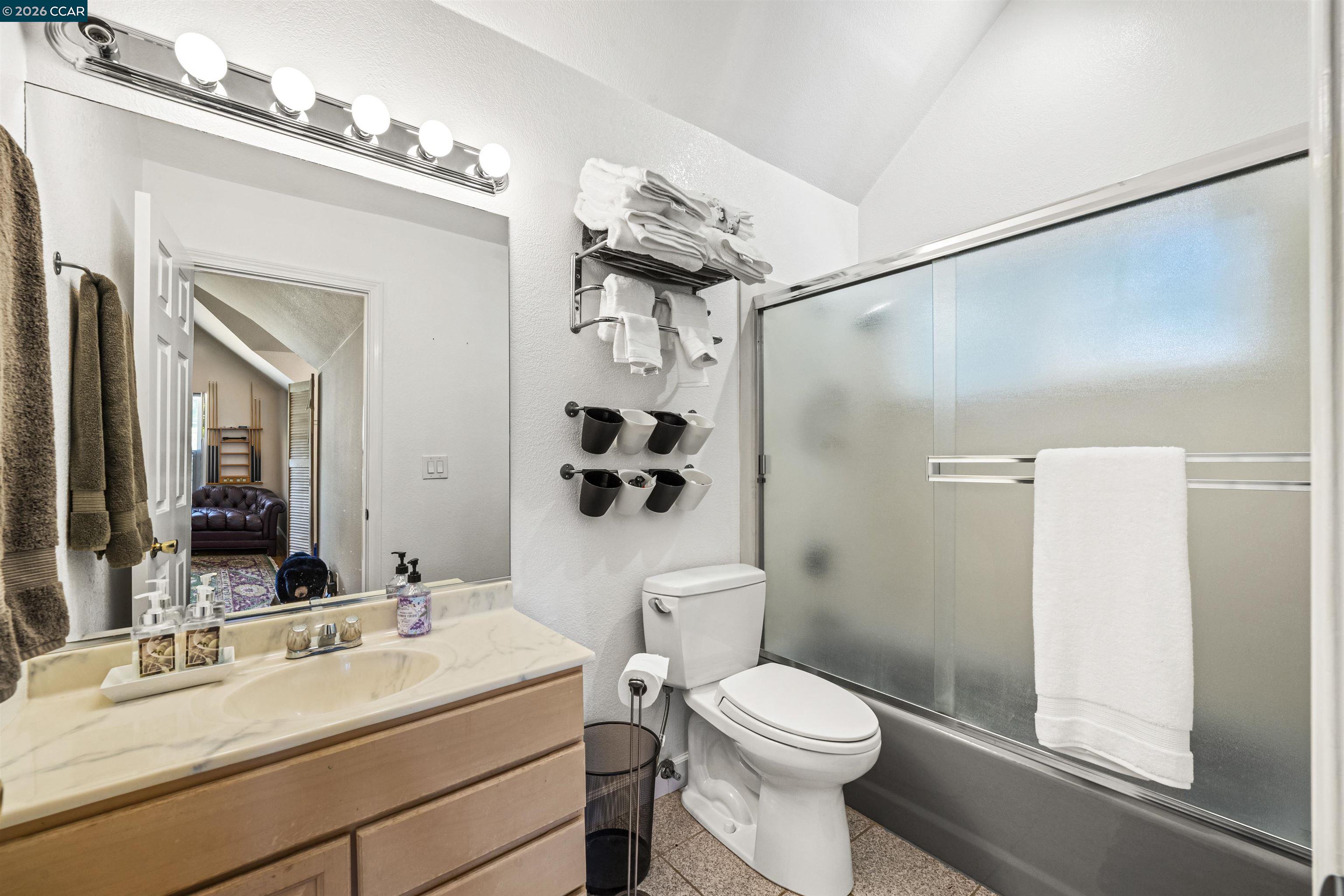 177 Oak Road Alamo, CA 94507 - Photo 44 of 85 a bathroom with a sink a toilet a mirror and shower