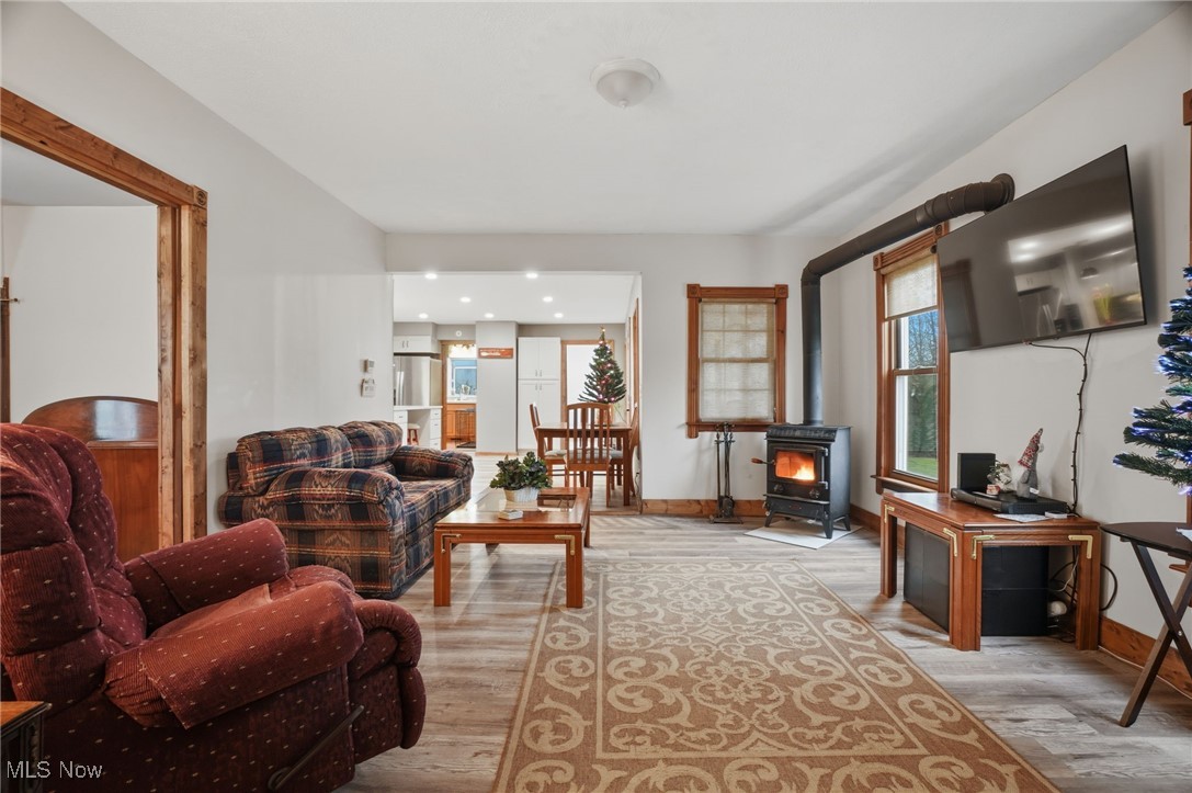 2146 Clay Road Dorset, OH 44032 - Photo 14 of 40 Living area featuring a wood stove and light wood finished floors