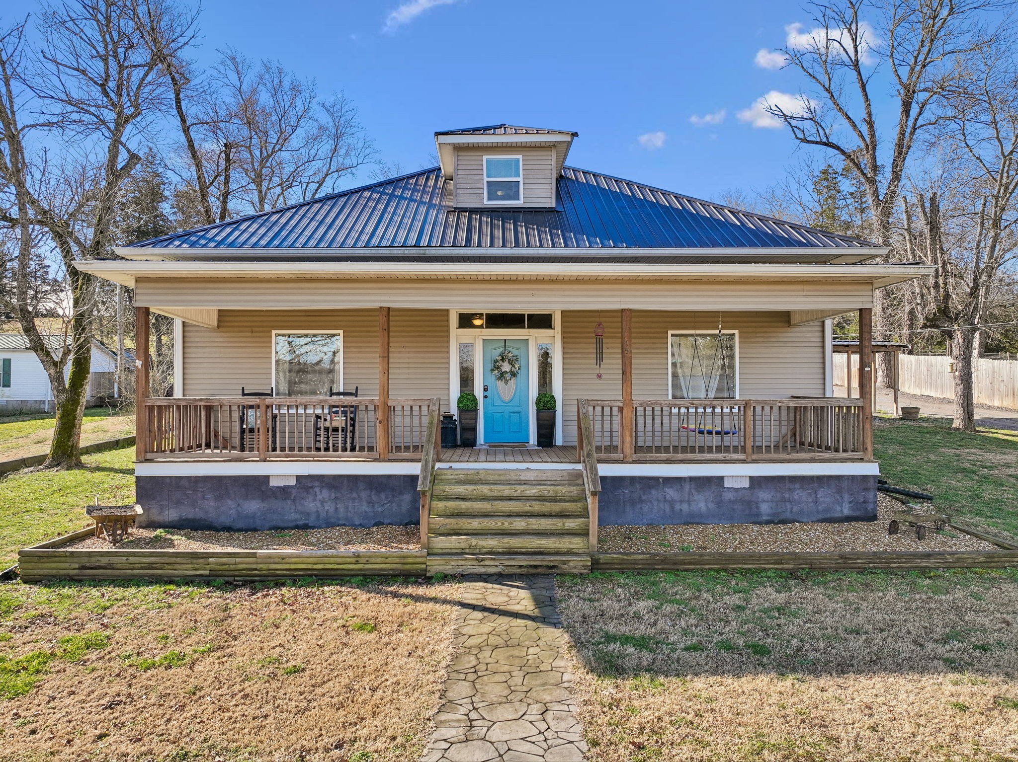 a view of house with a yard balcony and outdoor seating