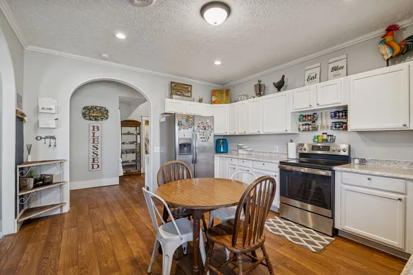 a view of a dining room with furniture wooden floor and chandelier