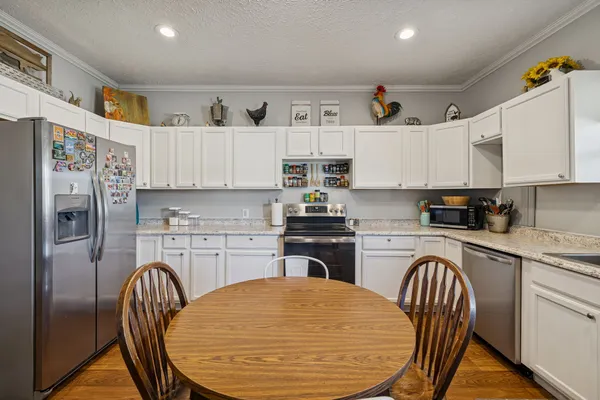 a dining room with furniture a fireplace and wooden floor