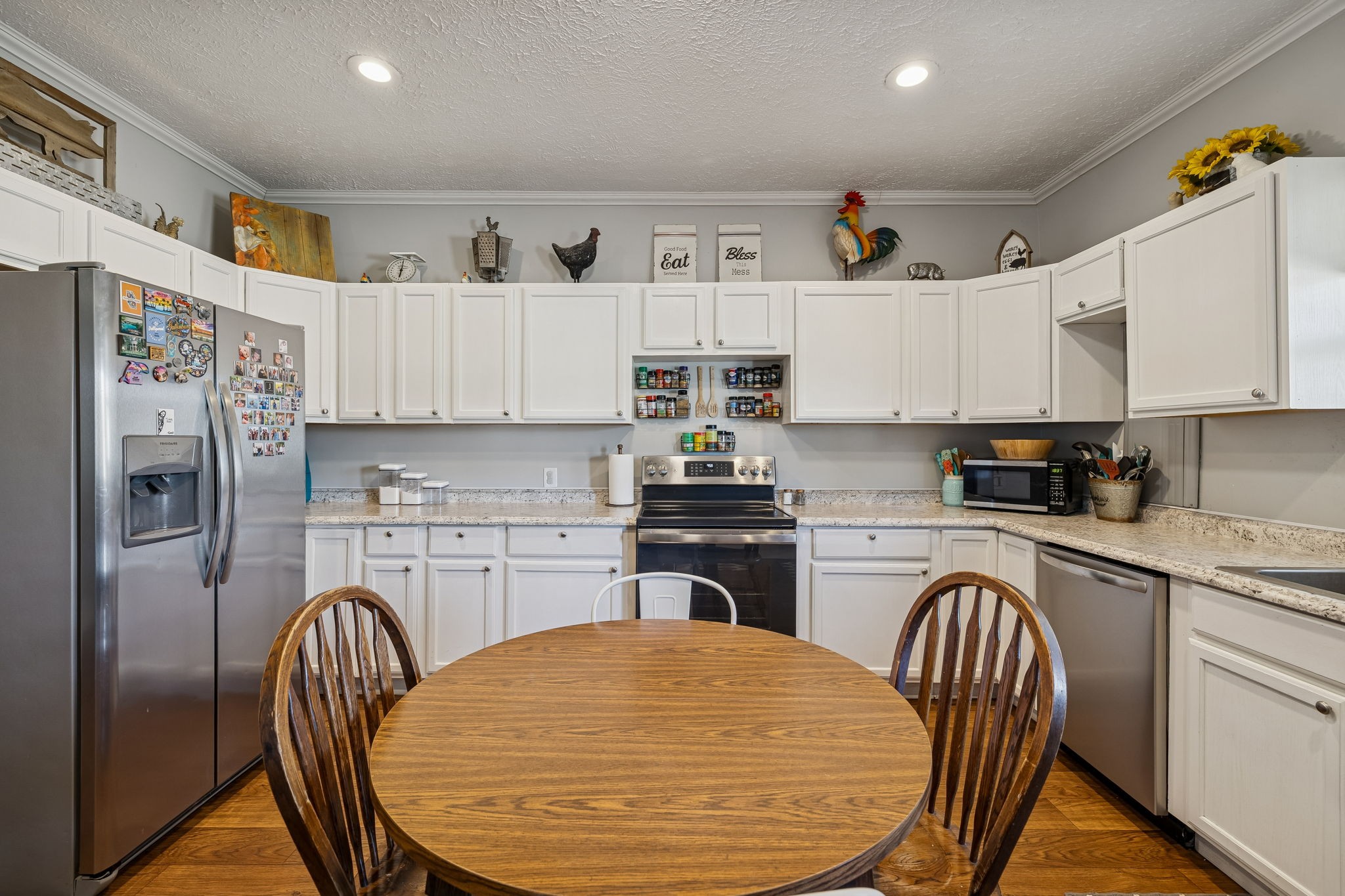 15 Switchboard Road Brush Creek, TN 38547 - Photo 18 of 60 a kitchen with stainless steel appliances granite countertop a refrigerator a stove a sink dishwasher and white cabinets with wooden floor