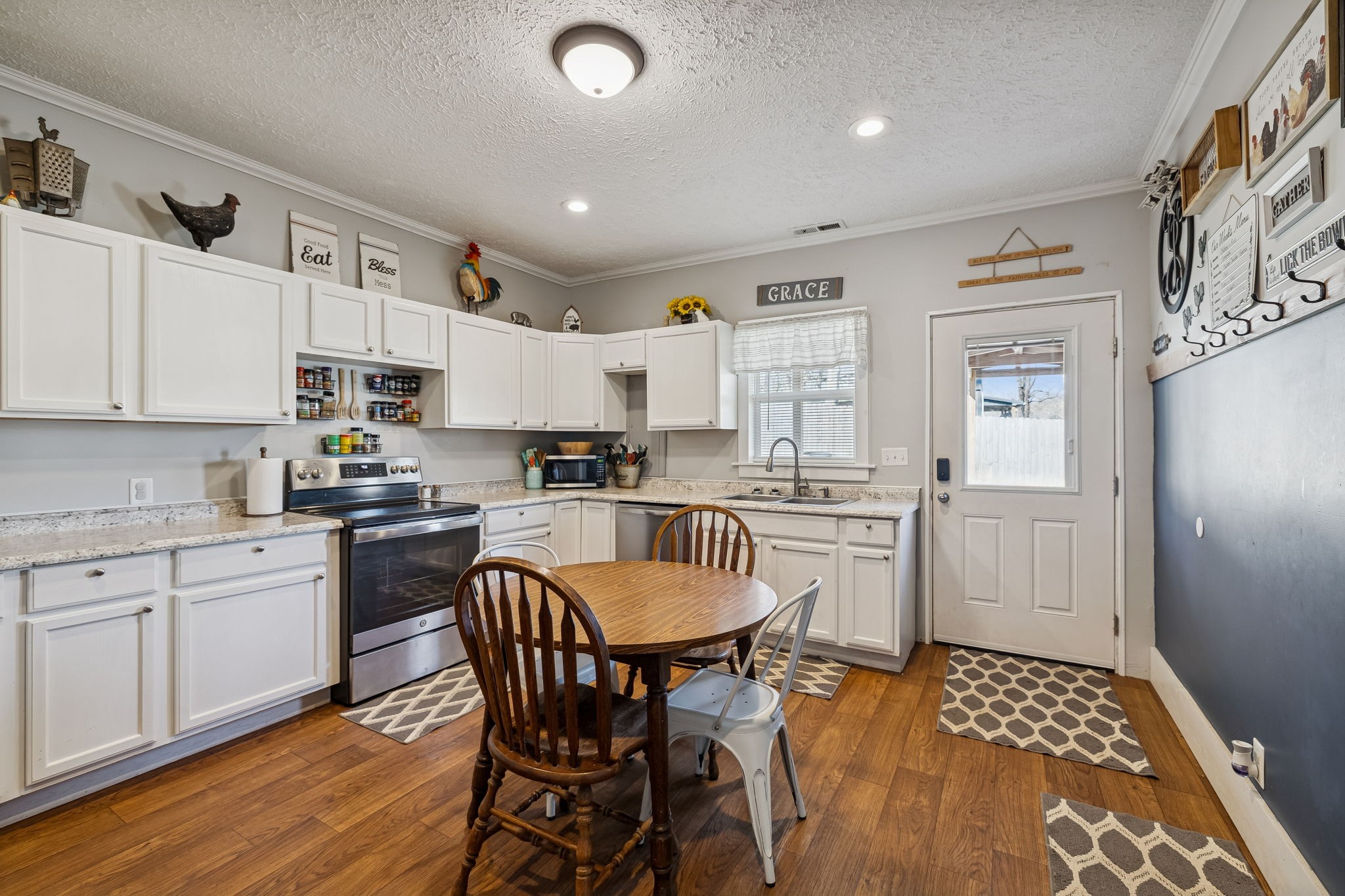 15 Switchboard Road Brush Creek, TN 38547 - Photo 19 of 60 a kitchen with a sink stove and white cabinets