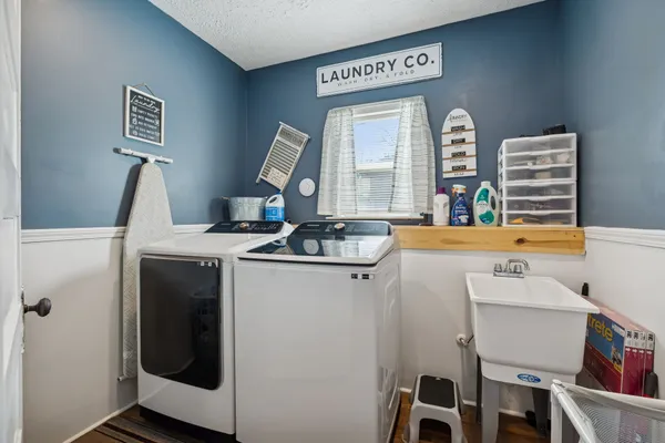 a bathroom with a sink a toilet and shower curtain