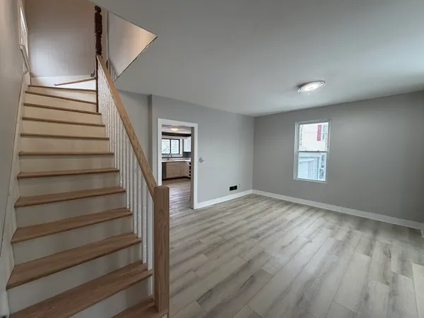 a view of an empty room with stairs and ventilation