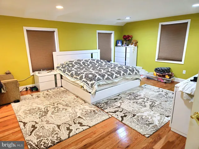 a bedroom with a bed couch and a window