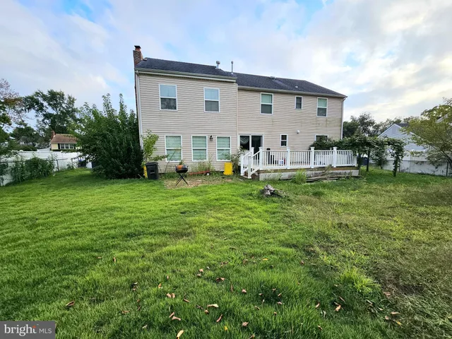 a view of a house with a backyard and a patio
