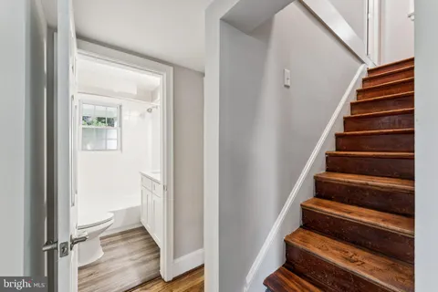 a view of a hallway with wooden floor and entryway