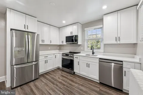 a kitchen with a refrigerator stove and sink
