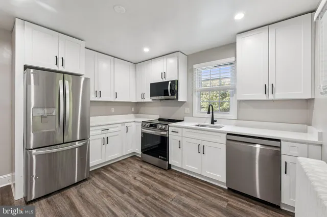 a kitchen with a refrigerator stove and sink