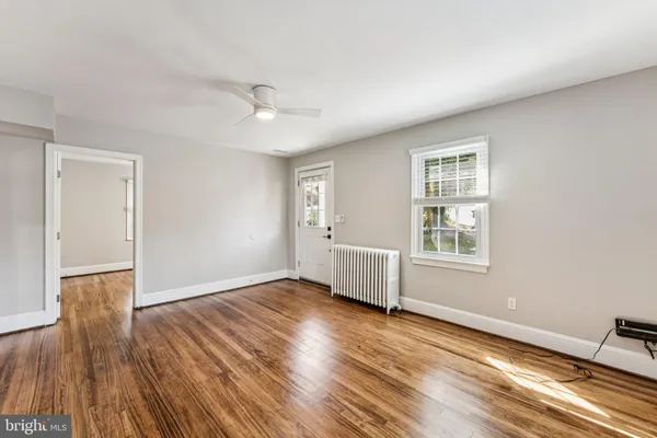 wooden floor in an empty room with a window