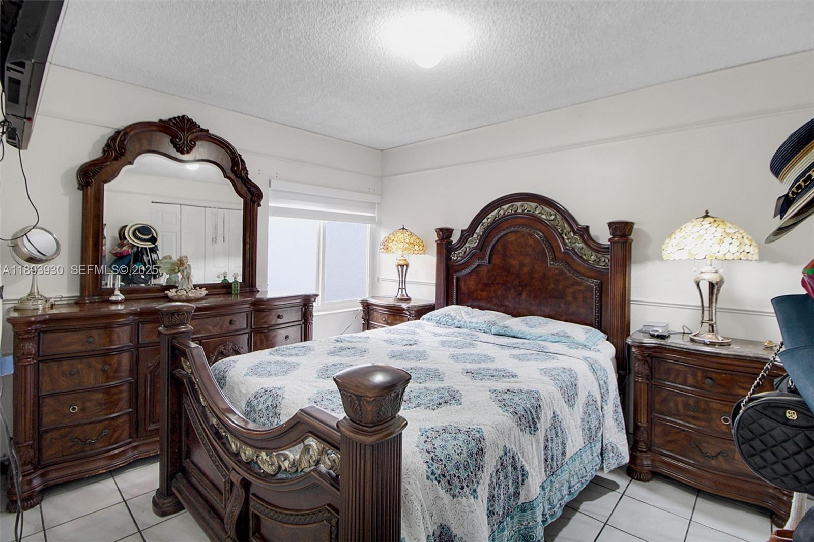 13246 Southwest 9th Terrace Miami, FL 33184 - Photo 14 of 34 a bedroom with a bed and dresser